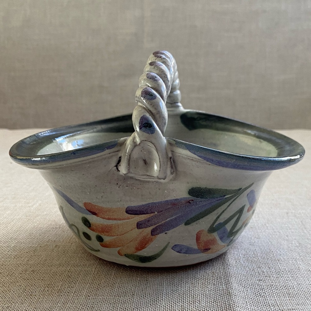 Signed ceramic bowl twisted handle, handmade.